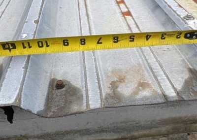 Measuring metal commercial panels by P-G Roofing Specialists