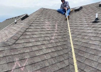 P-G Roofing and Construction technician on a roof